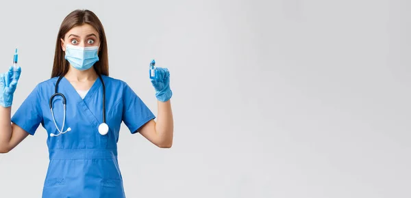 Covid-19，防止病毒、健康、保健工作者和检疫概念。兴奋的蓝刷子女护士、拿着注射器的诊所医生和使用考拉病毒疫苗的安保罗 — 图库照片