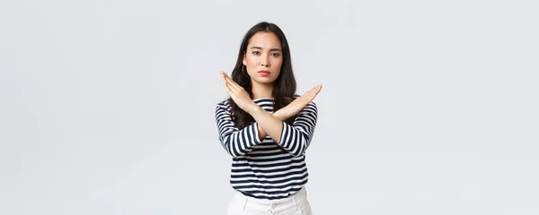 Lifestyle, beauty and fashion, people emotions concept. Serious-looking displeased asian woman tell to stop, showing cross sign in prohibition, disapprove action, give warning or restrain someone — Stock Photo, Image