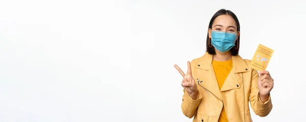 Hey you got point. Cheerful cute asian lively girl dark short haircut pointing camera finger-pistol smiling broadly, encourage friend make move, congratulate coworker good job, stand blue background — Stock Photo, Image