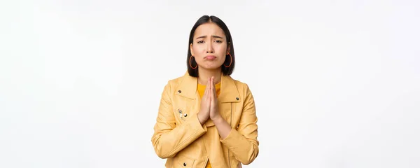 Image of hopeless asian woman begging, pleading, say sorry, looking distressed and miserable, standing over white background — Stock Photo, Image