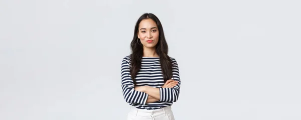 Lifestyle, beauty and fashion, people emotions concept. Skeptical and judgemental asian female office manager looking picky, smirk and pouting dissatisfied, cross arms chest — Stock Photo, Image