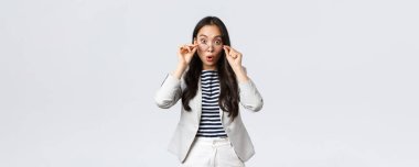 İş, finans ve istihdam, girişimci ve para kavramı. Şok olmuş Asyalı ofis hanımı kalkış gözlüğü ve geniş gözler büyük haberleri duyar gibi hayrete düşmüş, soluk soluğa, beyaz arka plan