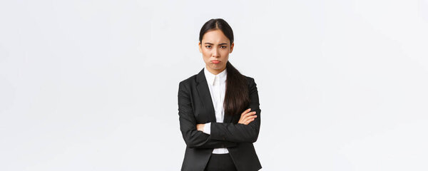 Insulted silly pouting saleswoman feeling angry at coworker, cross arms and sulking mad, frowning displeased, waiting for apology, standing upset over white background