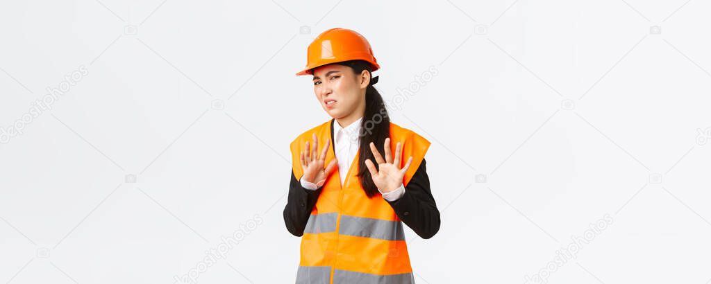 Reluctant and displeased asian female engineer refuse listen, showing stop, prohibit gesture, rejecting bothering offer, annoyed with clingy project manager, white background
