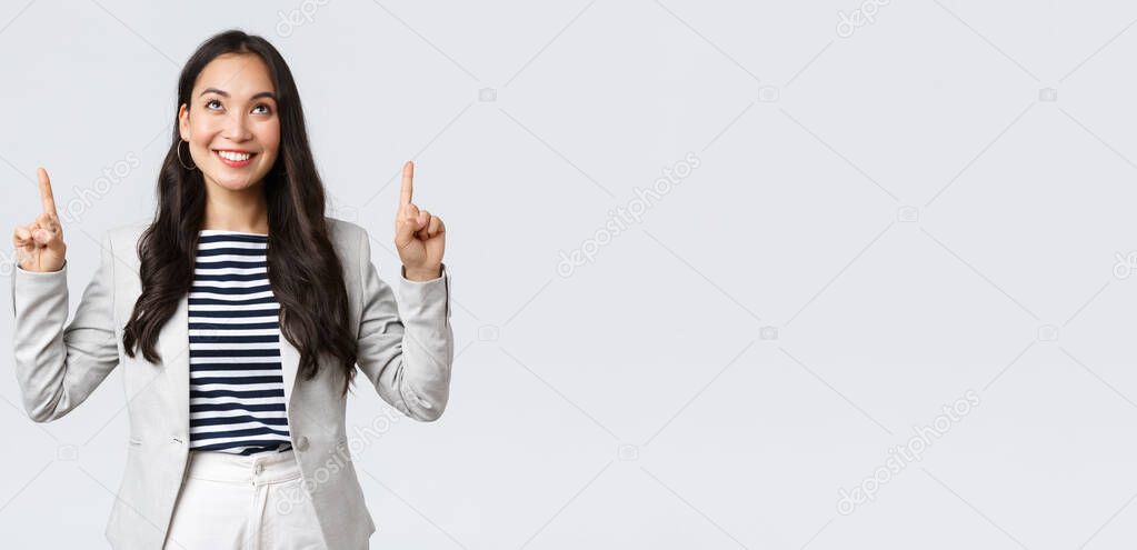 Business, finance and employment, female successful entrepreneurs concept. Successful confident smiling asian businesswoman pointing fingers up, real estate worker showing perfect proposal
