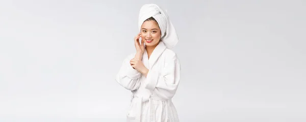 Portrait of a young happy asian lady in bathrobe.Isolated in white background. — Stock Photo, Image