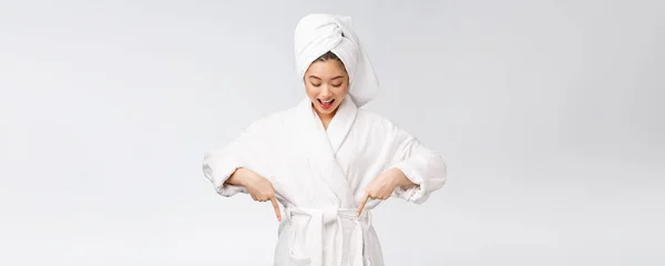 Retrato de belleza de mujer joven mostrando y señalando el dedo al espacio de copia vacío, belleza asiática en albornoz . — Foto de Stock