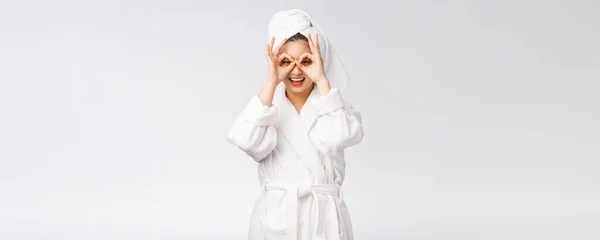 Close up de jovem mulher sorridente com o dedo ok gesto nos olhos, isolado no fundo branco — Fotografia de Stock