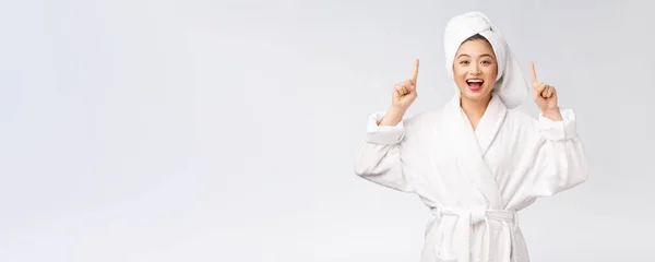 Beauty portrait of young woman showing and pointing finger to empty copy space, asian beauty in bathrobe. — Stock Photo, Image