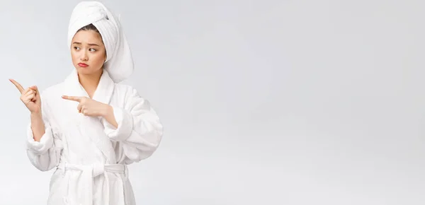 Young beautiful woman wearing shower towel after bath over isolated white background pointing with finger. — Stock Photo, Image