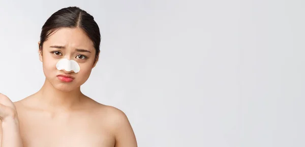 Kozmetológia. Gyönyörű ázsiai modell portréja maszkkal az orrán. Közeli egészséges fiatal nő tiszta puha bőr és friss természetes smink. — Stock Fotó