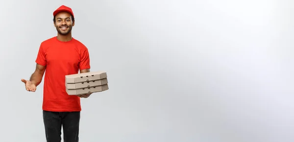 Delivery Concept - Portrait of Handsome African American Pizza delivery man. Isolated on Grey studio Background. Copy Space. — Stock Photo, Image