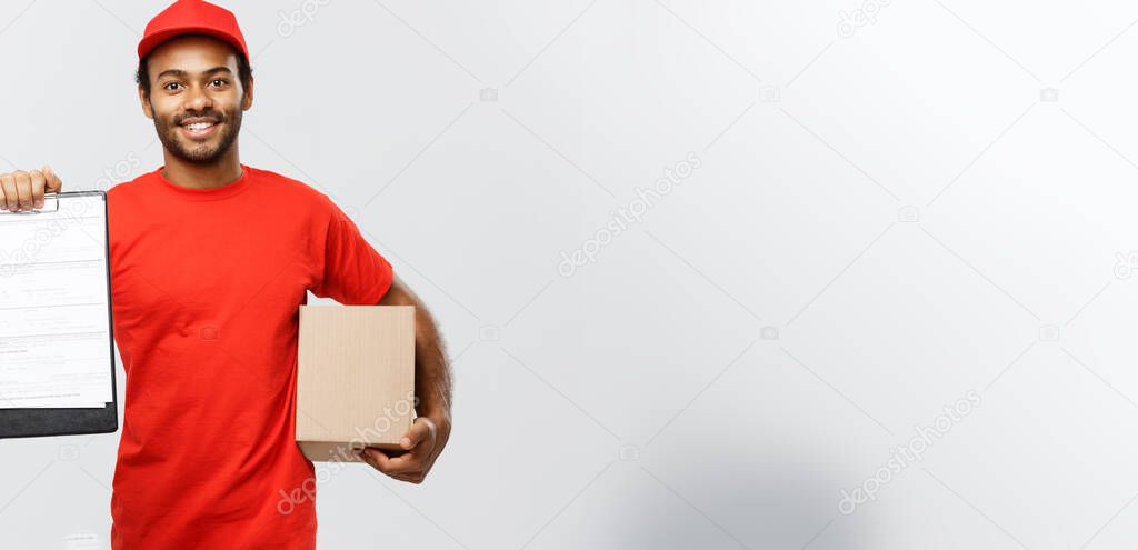 Delivery Concept - Portrait of Handsome African American delivery man or courier showing a confirmation document form to sign. Isolated on Grey studio Background. Copy Space.