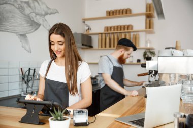 Kahve iş kavramı - güzel beyaz barmen barista veya Yöneticisi deftere nakil emri dijital tablet menüsünde modern kahve dükkanında.