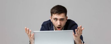İş kavramı - portre yakışıklı stresli iş adamı iş laptop arıyorum takım elbise şoka girmiş. Beyaz arka plan.