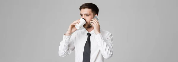 Business Concept - Portrait of a handsome businessman in eyeglasses with a cup of coffee and smartphone. — Stock Photo, Image