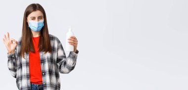 Coronavirus salgını, karantina, sosyal mesafeler ve duygu kavramı. Tıbbi maskeli hoş beyaz kadın bu sabunun virüsü önlemek için iyi olduğuna emin ol..