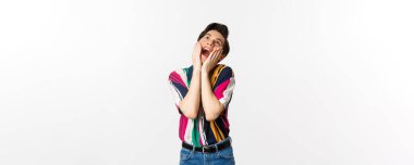 Heyecanlı eşcinsel bir adamın sevinç çığlıkları atarak yukarı bakması, kendinden geçmiş hissetmesi, beyaz arka planda durması..