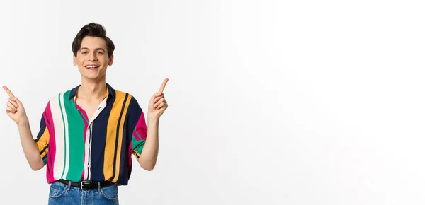 Happy Young Gay Man Pointing Fingers Sideways Showing Two Choices — Stock Photo, Image