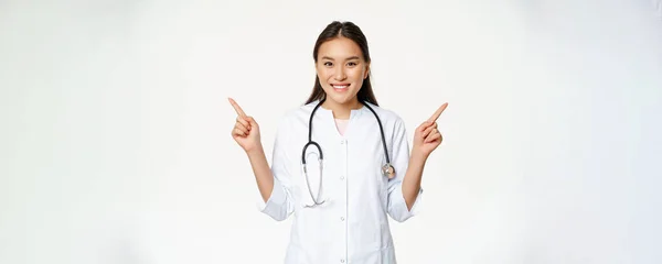 Smiling Professional Physician White Robe Pointing Fingers Sideways Showing Two — Stock Photo, Image