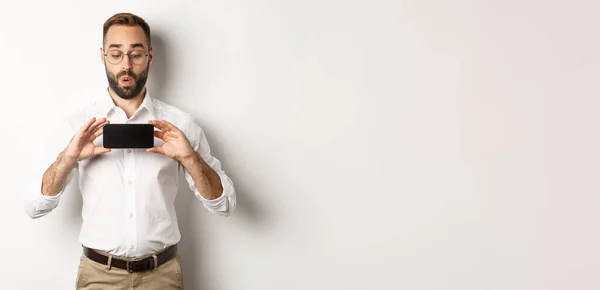 Amused Handsome Guy Showing Mobile Screen Looking Excited Online Website — Stock Photo, Image