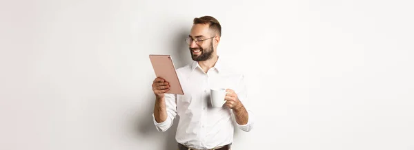 Schöner Geschäftsmann Trinkt Kaffee Und Liest Auf Digitalem Tablet Lächelt — Stockfoto