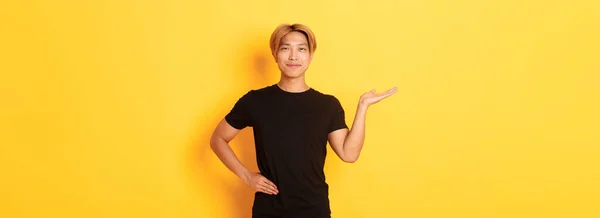 Portrait Happy Proud Smiling Asian Guy Holding Something Hand Yellow — Stock Photo, Image