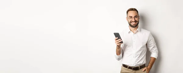 Handsome Manager Using Smartphone Smiling Pleased Sending Text Message Standing — Stock Photo, Image