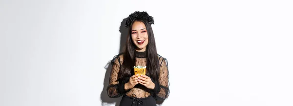 Cheerful Pretty Asian Woman Celebrating Halloween Witch Costume Holding Sweets — Stock Photo, Image