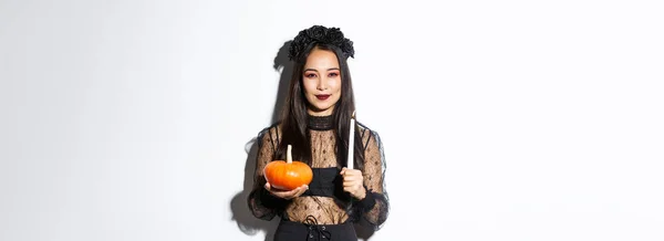 Image Devious Smiling Asian Witch Gothic Dress Holding Candle Pumpkin — Stock Photo, Image