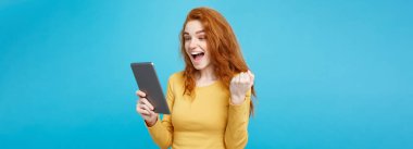 Portre genç güzel çekici Dişileştirilmiş kız dijital masada bir şey yeme içme ile gülümseyen mutlu kapatın. Mavi Pastel renkli. Kopya alanı.