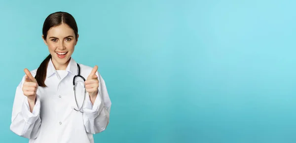 Enthusiastic Woman Doctor Smiling Pointing Fingers Camera Congratulating Inviting Patients — Stok fotoğraf