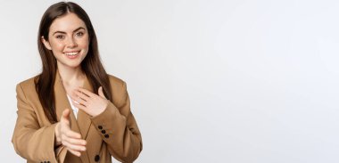 Portrait of smiling businesswoman extend hand for handshake, greeting business partner, saleswoman welcome client, white background.