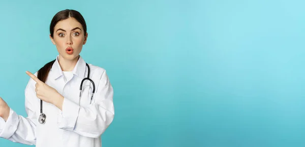 Portrait Smiling Medical Worker Girl Doctor White Coat Stethoscope Pointing — Fotografia de Stock