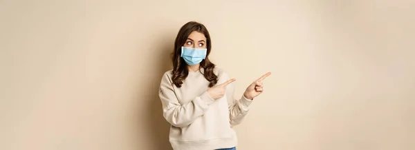Health Covid Concept Cute Brunette Woman Medical Face Mask Pointing — Foto de Stock