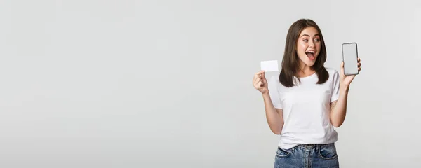 Garota Bonito Animado Surpreso Mostrando Cartão Crédito Aplicativo Bancário Telefone — Fotografia de Stock