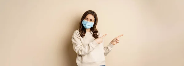 Health Covid Concept Confused Young Woman Medical Face Mask Pointing — стоковое фото