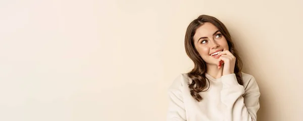 Cute Modern Woman Thinking Daydreaming Smiling Looking Thoughtful Standing Beige — Zdjęcie stockowe