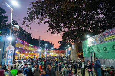 Kolkata, West Bengal, India - 12th January 2020 : Hindu Devotees walking in the evening at Gangasagar transit camp to visit and get blessings of Hindu sadhus at their camps , at Babughat, Kolkata.