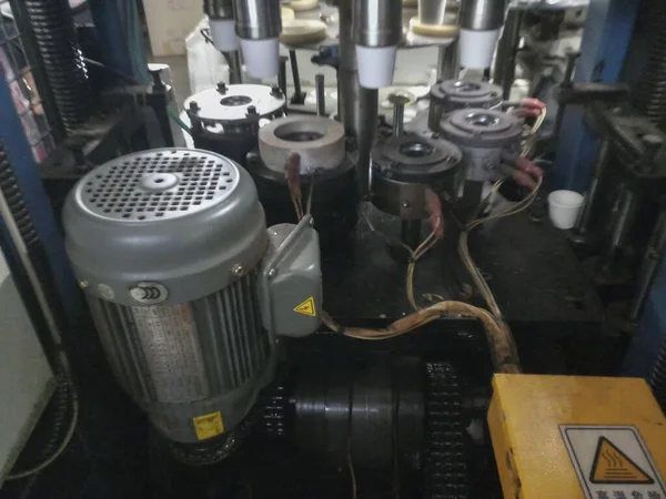 Kolkata, Batı Bengal, Hindistan - 17 Mayıs 2019: Kağıt bardaklar kağıt bardak üretim makineleri kullanılarak kağıttan yapılıyor, çalışan bir bardak imalatı veya üretim ünitesinin iç görünümü.