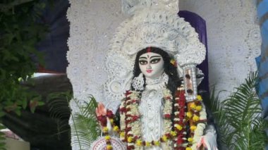 Face of Goddess Saraswati , dressed in white, being worshipped inside pandal, Howrah, West Bengal, India.