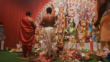 Howrah, India - October 15th, 2021 : Sandhi Puja, the sacred juncture of Ashtami, eighth day and Nabami, nineth day, as Hindu ritual for praying to Goddess Durga. Durga puja festival.