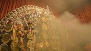 Howrah, India - October 15th, 2021 : Holy smoke is covering Goddess Durga on Sandhi Puja, the sacred juncture of Ashtami, eighth day and Nabami, nineth day, as Hindu ritual for praying to Goddess.