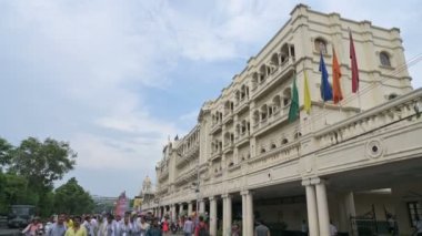 Kolkata, West Bengal, India - 21st July 2022 : Iconic Grand Hotel at Esplanade, Dharmatala area with waving flags and blue sky background. Colonial architecture.