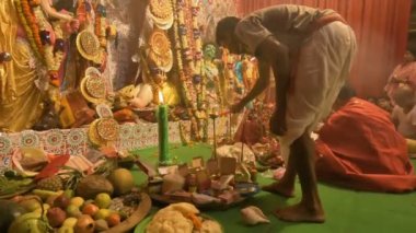 Howrah, India - October 15th, 2021 : Holy candle is being lit during Sandhi Puja, the sacred juncture of Ashtami, eighth day and Nabami, nineth day, as Hindu ritual for praying to Goddess Durga.
