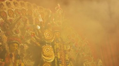 Howrah, India - October 15th, 2021 : Holy smoke is covering Goddess Durga on Sandhi Puja, the sacred juncture of Ashtami, eighth day and Nabami, nineth day, as Hindu ritual for praying to Goddess.