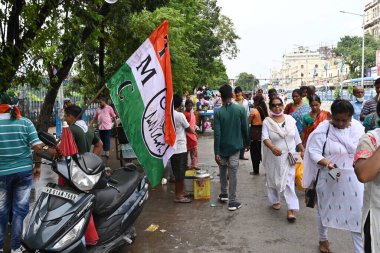 Kolkata, West Bengal, India - 21st July 2022 : All India Trinamool Congress Party, AITC or TMC, at Ekushe July, Shadid Dibas, Martyrs day rally. Party supporters arriving on sccoters with party flag.