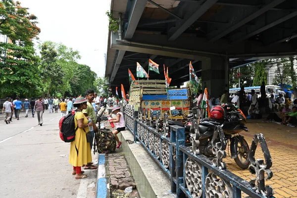 Kolkata, West Bengal, India - 21st July 2022 : All India Trinamool Congress Party, AITC or TMC, at Ekushe July, Shadid Dibas, Martyrs day rally. Party supporter arriving with family and kid.