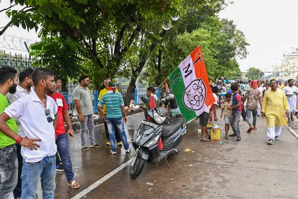 Kolkata, West Bengal, India - 21st July 2022 : All India Trinamool Congress Party, AITC or TMC, at Ekushe July, Shadid Dibas, Martyrs day rally. Party supporters arriving on sccoters with party flag.