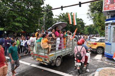 Kolkata, West Bengal, India - 21st July 2022 : All India Trinamool Congress Party, AITC or TMC, at Ekushe July, Shadid Dibas, Martyrs day rally. Cheerful women supporters arriving in party van.